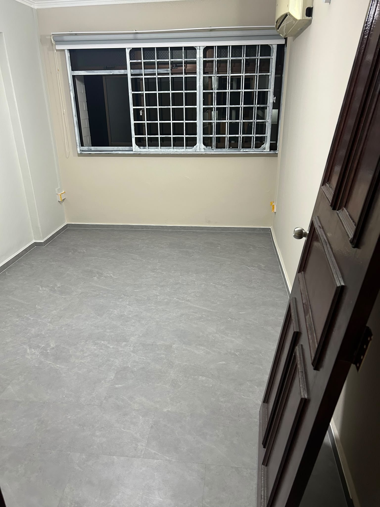 Grey stone-look vinyl flooring in a Singapore bedroom