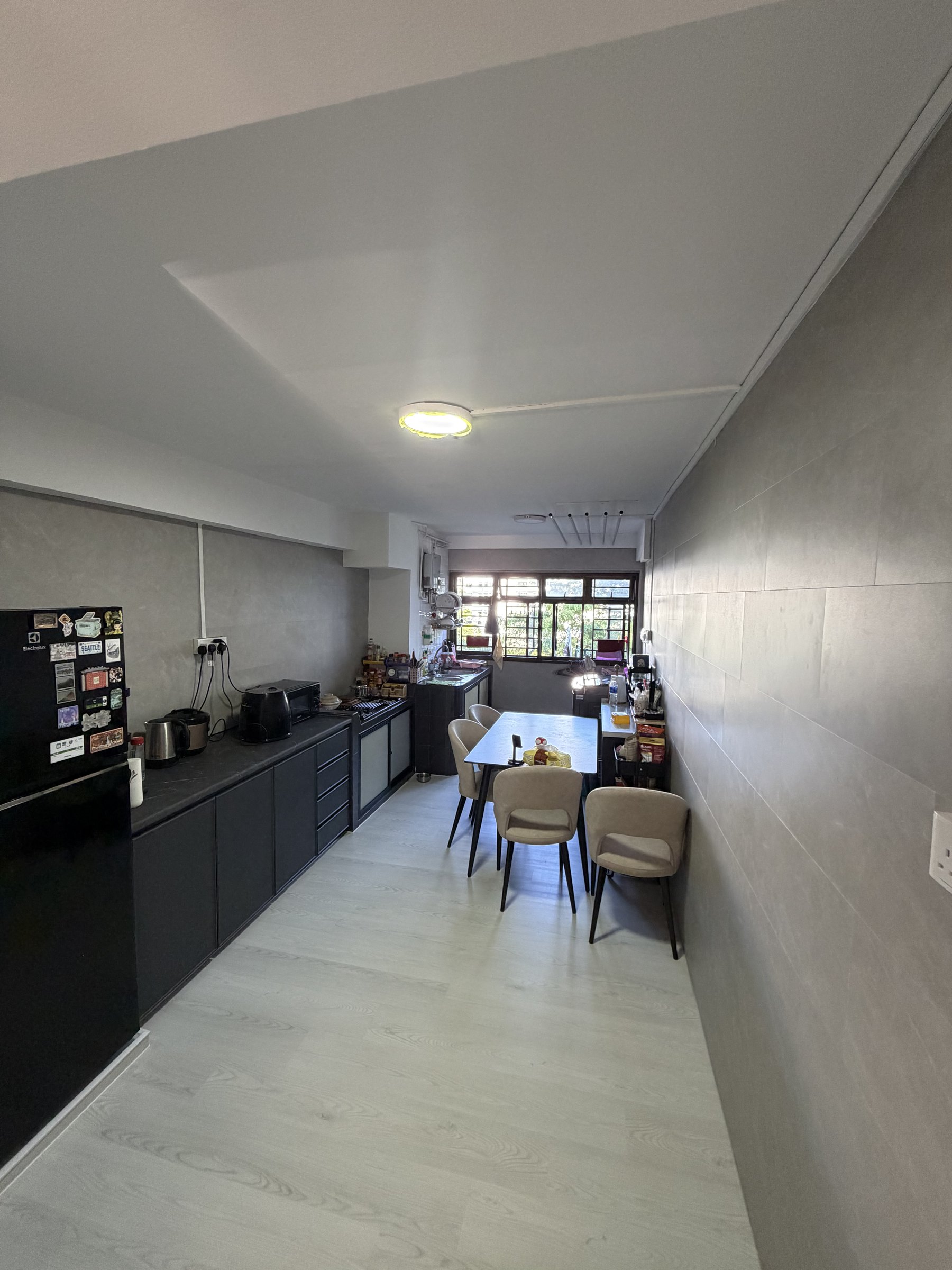 Light grey wood-look vinyl flooring in a bright Singapore living area
