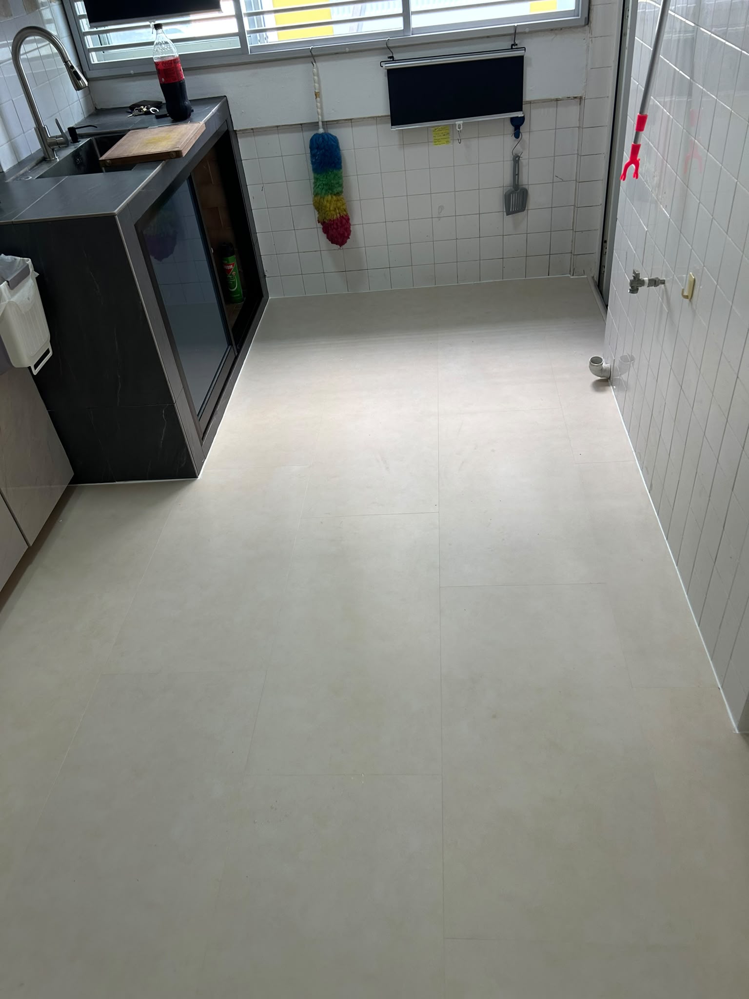 Light stone-look vinyl flooring in a Singapore HDB kitchen