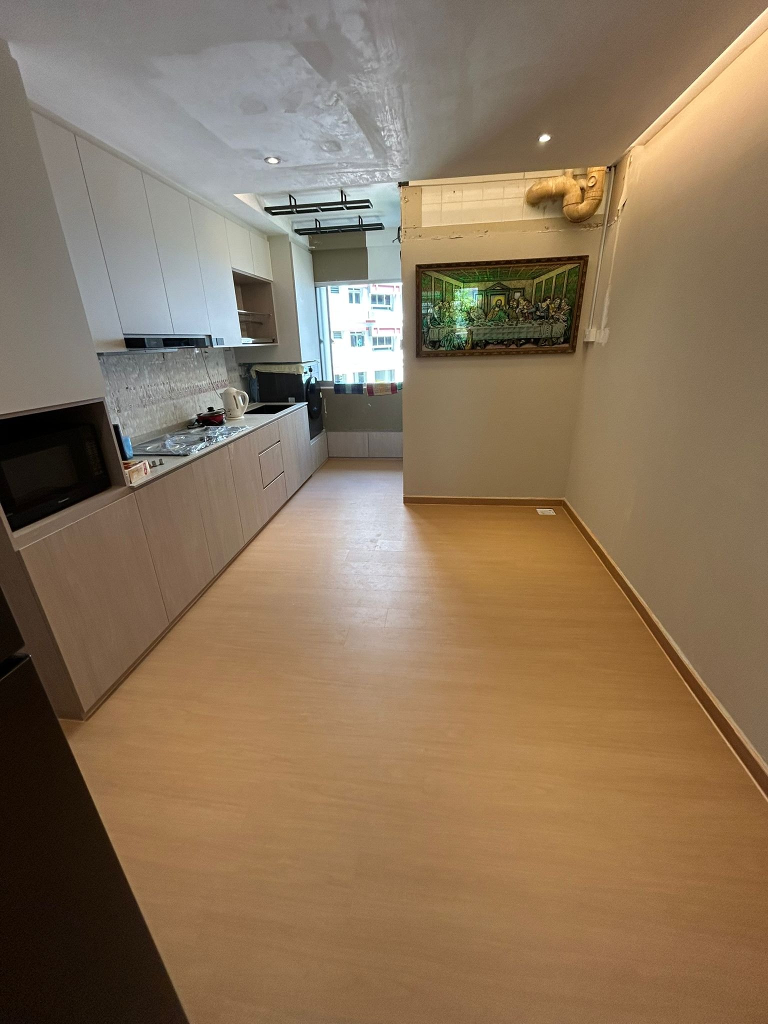 Natural oak vinyl flooring in a Singapore HDB kitchen