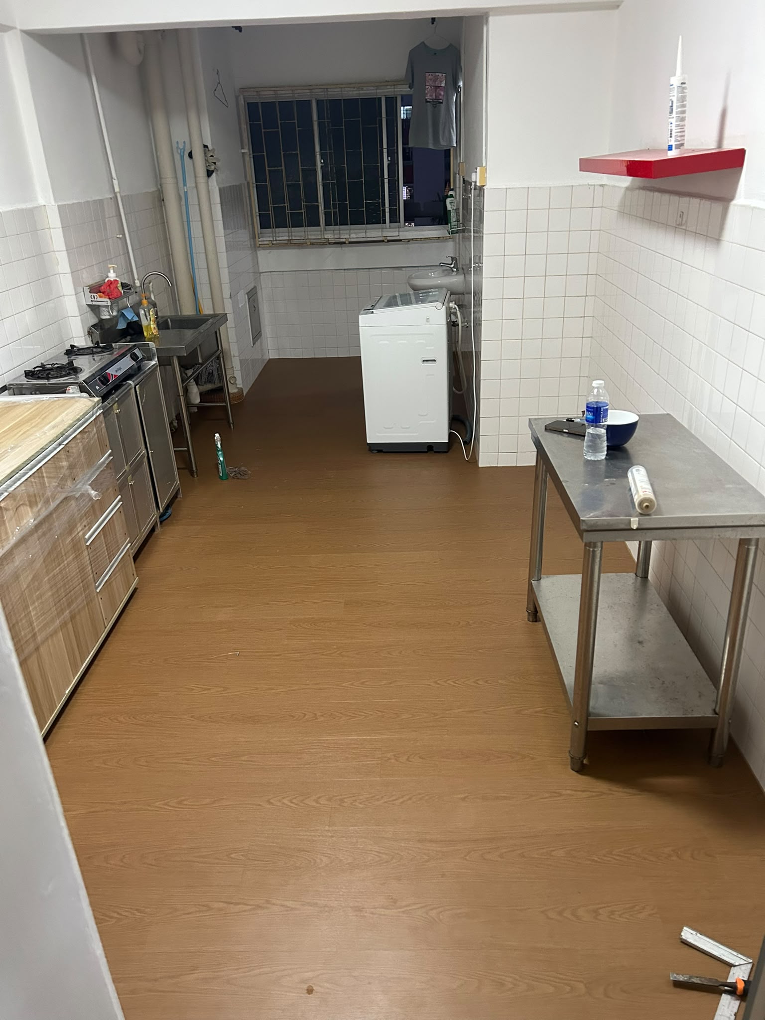 Warm oak wood-look vinyl flooring in a Singapore HDB kitchen