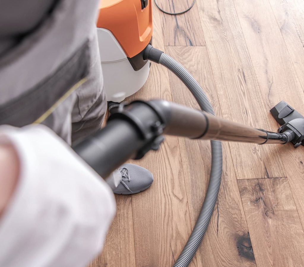 male-worker-vacuuming-hardwood-flooring-.jpg